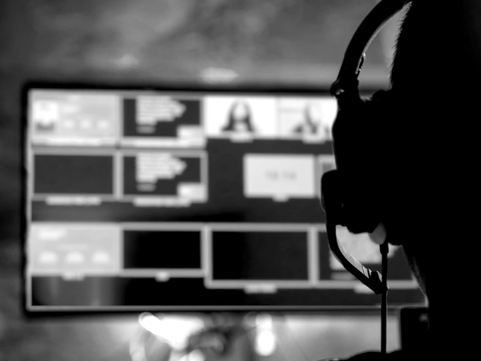 Technician with headset in front of monitors directing a virtual event