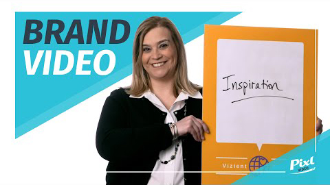 Brand Video text, woman holding a sign that says Inspiration, Vizient employee