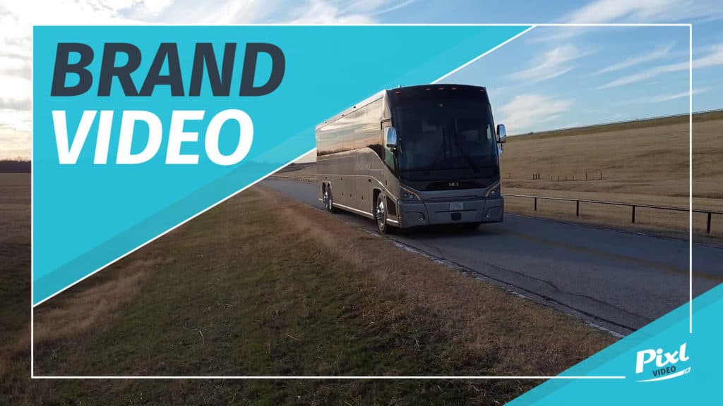 Image of a motor coach on a highway, shot by a drone demonstrating commercial brand video production services