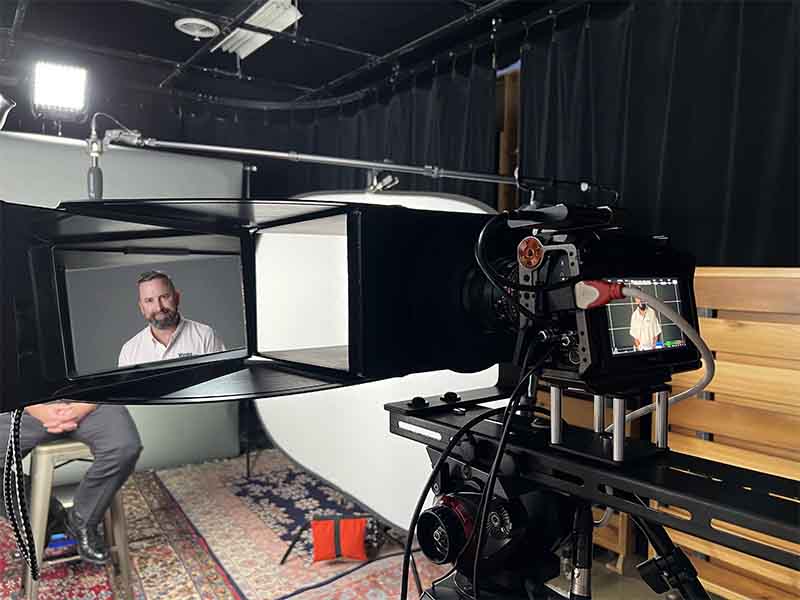Producer's view of interview subject through an EyeDirect device attached to the font of a video camera
